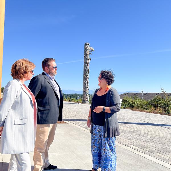 Sheila Malcolmson, MLA for Nanaimo, Richard Horbachewski and Lillian Morton tour the outside of Shq’apthut