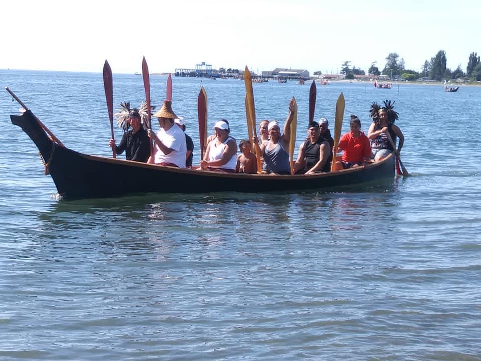 People in a canoe approach the shore