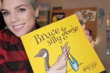 VIU alum Amy Pye holding her new children's book