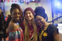 Three women smile at camera