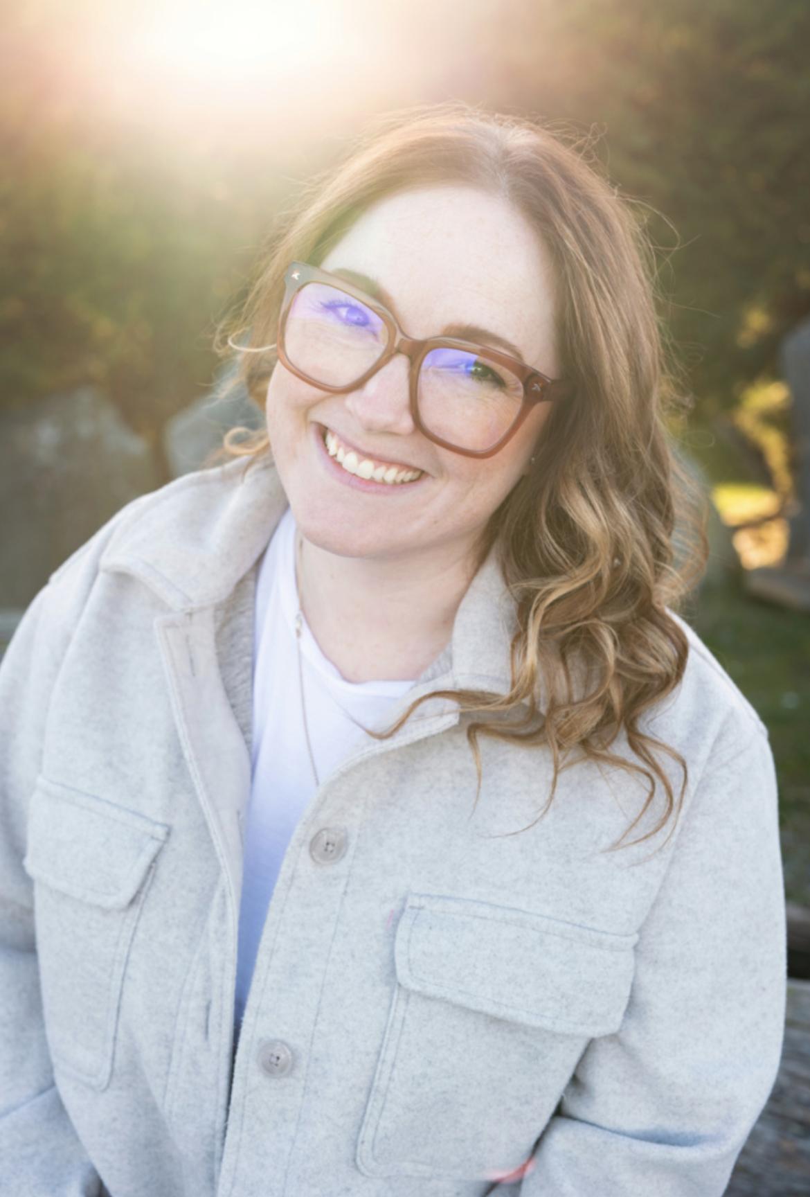 Ashley Kuramoto smiles with a natural and/or garden background