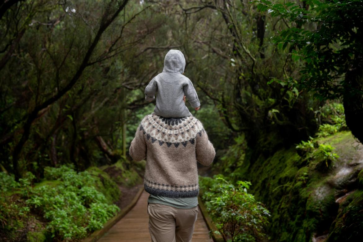 Man with baby in forest