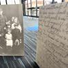 A picture of a solider and his family to the left, a copy of a letter in the foreground